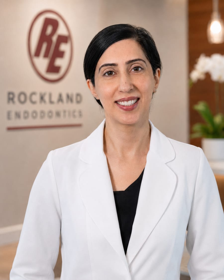 Dr. Monica Juneja in a white coat at the Rockland Endodontics office